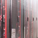 Modern data server room with network racks and cables.